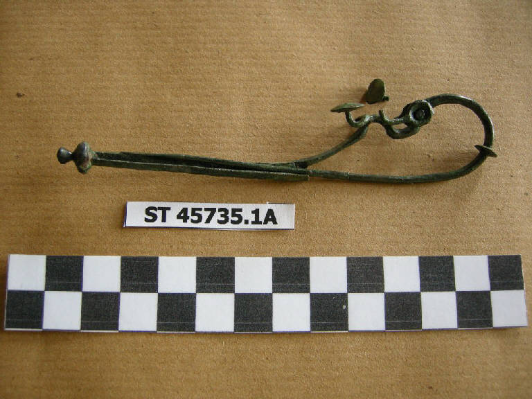 fibula a drago - cultura di Golasecca (fine/inizio secc. VII/ VI a.C.)