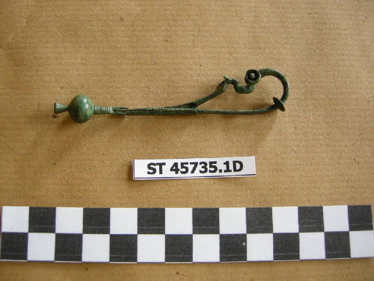 fibula a drago - cultura di Golasecca (fine/inizio secc. VII/ VI a.C.)
