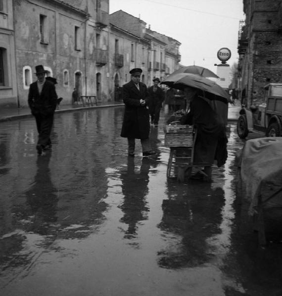 Italia del Sud. Calabria - mercato - venditore ambulante sotto la pioggia