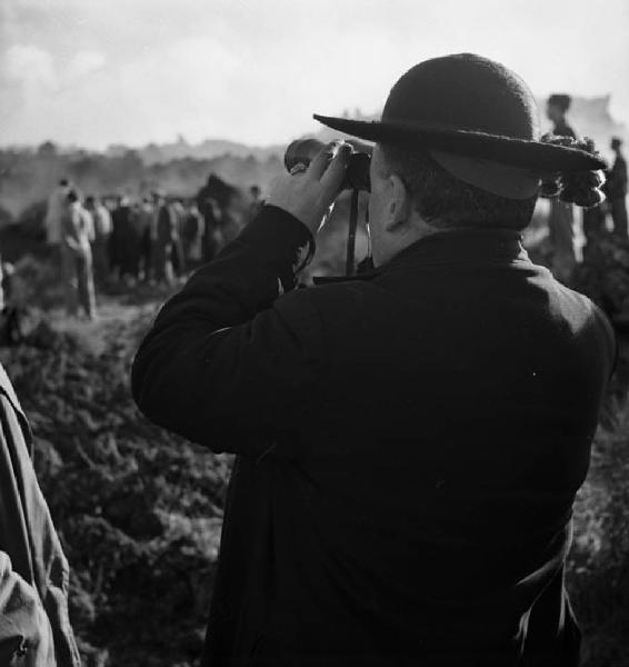 Italia del Sud. Sicilia - eruzione dell'Etna - processione lungo le pendici del vulcano - prelato osserva con il binocolo