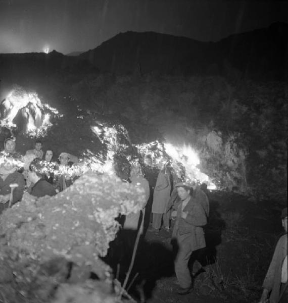 Italia del Sud. Sicilia - eruzione dell'Etna - processione lungo le pendici del vulcano - persone vicino alla lingua di lava