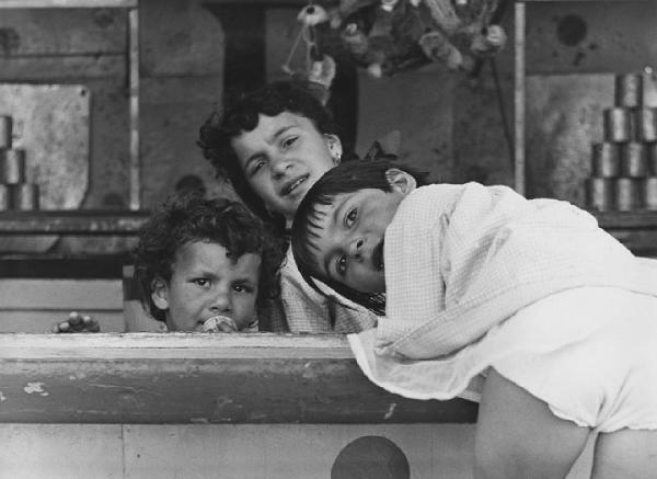 Luna park. Milano - Luna park - Stand del tiro a segno - Ritratto di gruppo: bambini appoggiati al bancone - Biancheria intima a vista