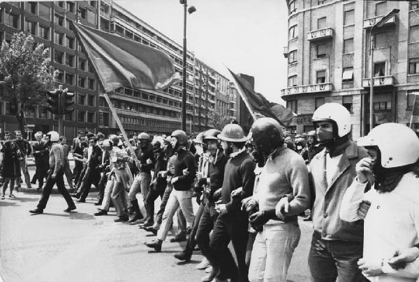 Manifestazioni anni '70. Milano - Manifestazione del primo maggio - Servizio d'ordine del Movimento studentesco - Giovani con bandiere e caschi