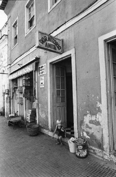 Laguna - scorcio urbano - bambina seduta sulla soglia di casa