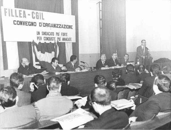 Camera del Lavoro - Sala "Bruno Buozzi" - Interno - Convegno Fillea Cgil - Tavolo della presidenza - Oratore al microfono - Parola d'ordine