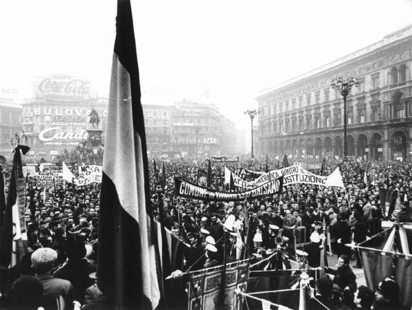 Manifestazione unitaria antifascista - Piazza del Duomo - Comizio conclusivo - Folla di manifestanti - Striscioni - Cartelli - Bandiere - Monumento a Vittorio Emanuele II - Pubblicità sulle pareti dei palazzi