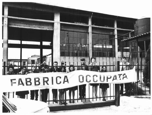 Occupazione del Calzificio Impero - Lavoratori dietro al cancello della fabbrica - Striscione