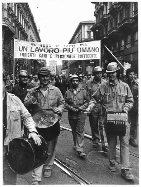 Sciopero dei lavoratori della Breda Siderurgica per l'ambiente di lavoro - Corteo in via Dante - Operai con tuta da lavoro - Striscione - Bandiere - Tamburi