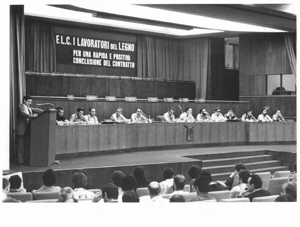 Sala dei Congressi della Provincia - Interno - Convegno unitario dei lavoratori del legno - Tavolo della presidenza - Oratore al microfono - Parola d'ordine