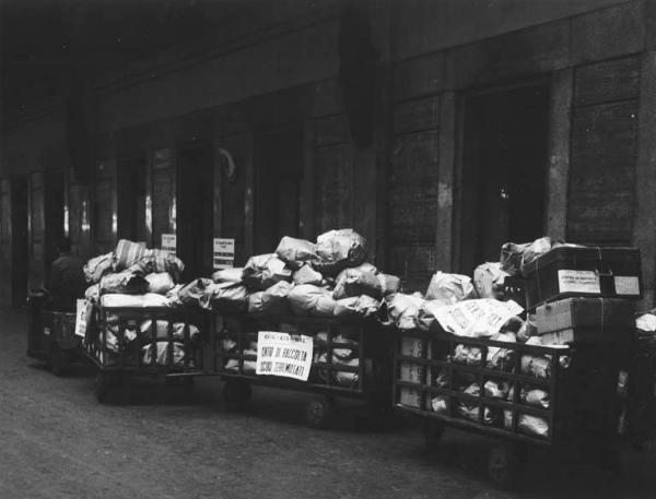 Stazione Centrale - Centro di raccolta soccorsi terremotati di Cgil, Cisl e Uil - Carrelli porta bagagli - Trasporto dei pacchi per i terremotati