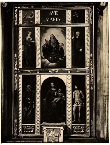 Maggianico - Chiesa parrocchiale - Bernardino Luini, Madonna con Bambino, Dio Padre e ai lati i SSanta Caterina, Antonio, Andrea e Sebastiano, polittico, olio su tela (1515 ca -)