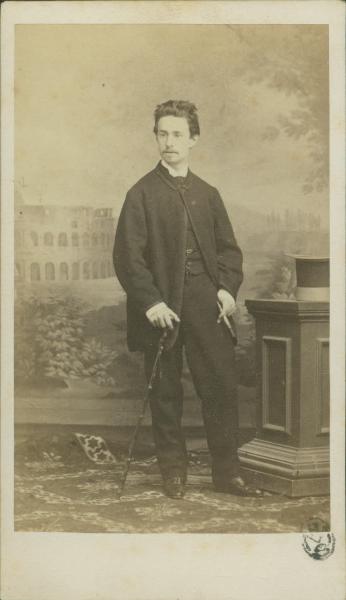 Ritratto maschile - Giovane con bastone da passeggio, in piedi accanto a un basamento