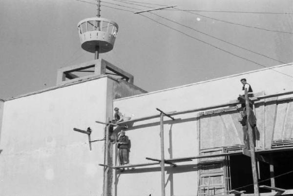 Prima Mostra Triennale delle Terre Italiane d'oltremare - settore storico - fondaco veneziano in costruzione - operai sulle impalcature