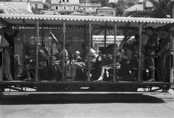 Viaggio in Jugoslavia. Dubrovnik (Ragusa): scene di vita quotidiana - gruppo di persone seduto in una vettura tramviaria