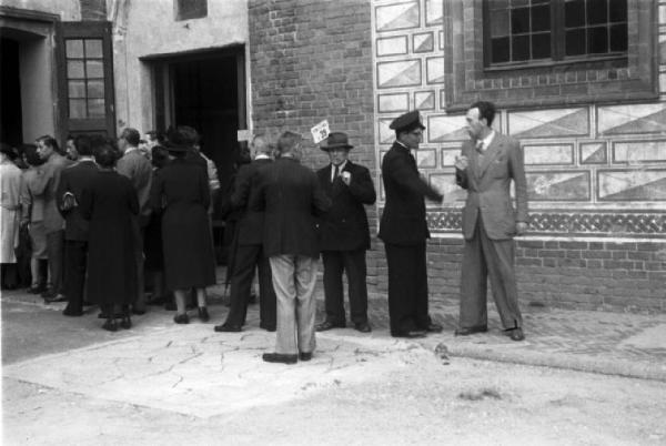 Referendum 1946 Repubblica o Monarchia. Milano - Ufficio elettorale - Cittadini e cittadini in fila all'entrata