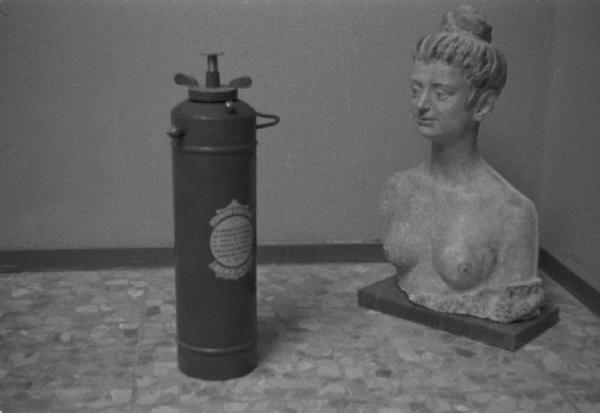 Roma. Palazzo delle Esposizioni. IV Quadriennale. Allestimento mostra - scultura di busto femminile accanto a un estintore