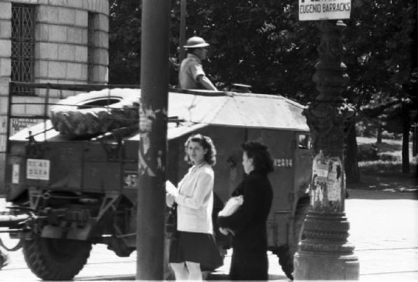 Italia Dopoguerra. Milano. Mezzo militare nei pressi dell'Arco della Pace - donne di passaggio