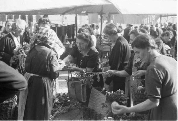 Italia Dopoguerra. Milano. Vendita al mercato di prodotti a prezzi calmierati. Folla di donne davanti a un banco