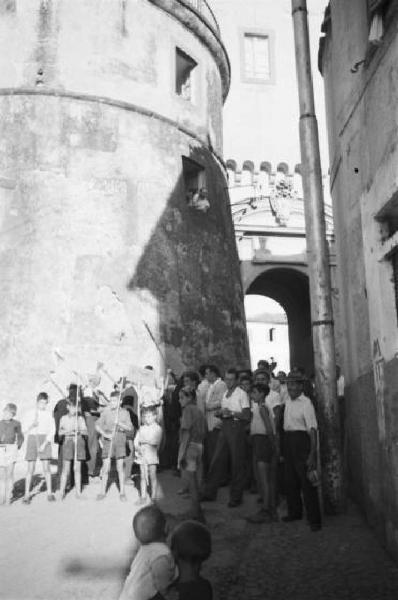 Invasione delle terre. Gruppo di contadini e bambini con cartelli occupano un vicolo del centro abitato