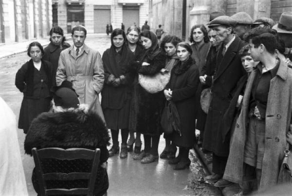 Italia Dopoguerra. Palermo. Gruppo di persone presso la chiromante