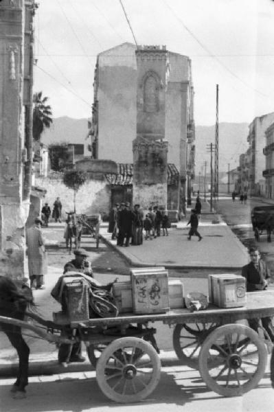 Italia Dopoguerra. Palermo. Carretto con casse in legno sosta all'angolo di una strada