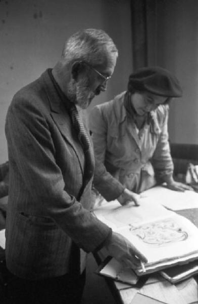 Parigi. Robert Naly mostra alcuni lavori a una donna nel suo studio a Montmartre