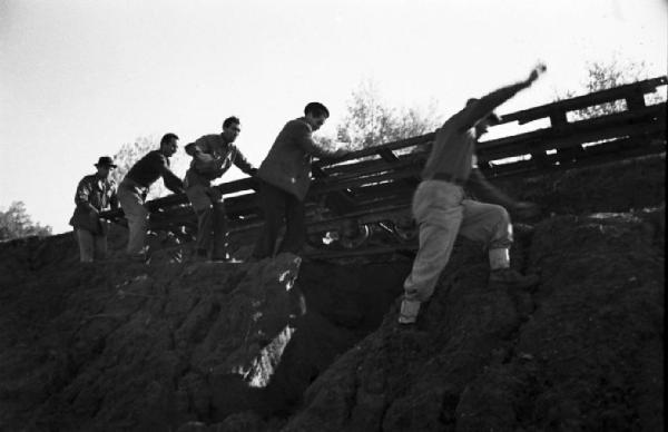 Italia Dopoguerra. Roma. Ponte sul Tevere in costruzione. Opere di consolidamento lungo le sponde del fiume. Operai al lavoro su una massicciata