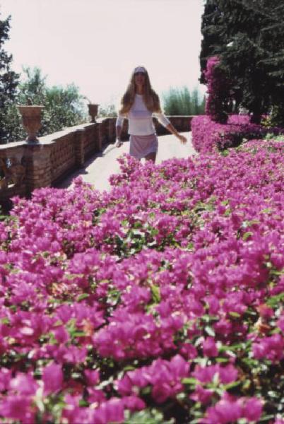 Campagna pubblicitaria Ellesse. Fotomodella indossa completo da tennis bianco e rosa - fiori di azalea