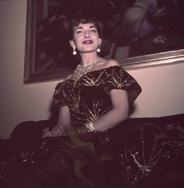 Milano - Abitazione di Maria Callas: interno - Ritratto femminile: Maria Callas (cantante lirica) seduta su divano - Costume di scena La Traviata