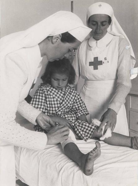 Riccione - Colonia Guido Donegani per bambini sfollati - Infermeria - Infermiere con bambina