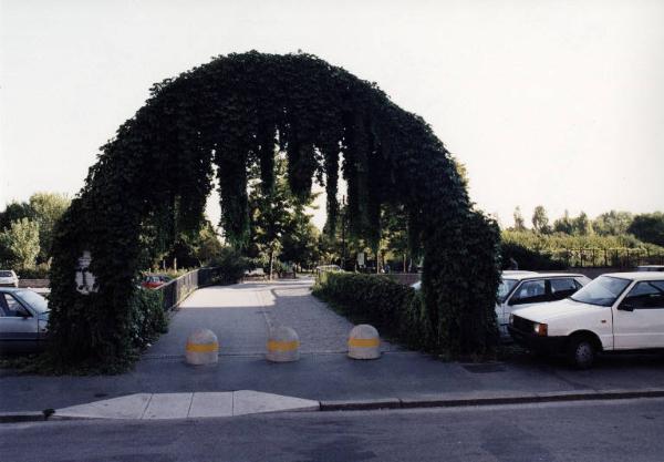 Milano - Parco Nord, settore Montagnetta - Ingresso al parco di via Suzzani - Arco con edera - Dissuasori stradali in cemento - Parcheggio auto