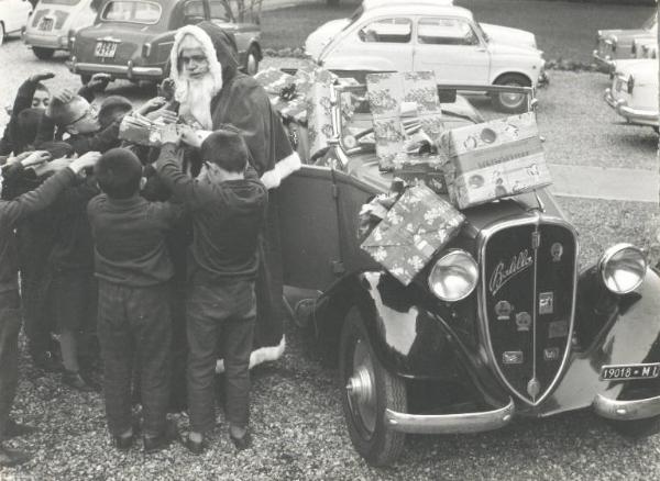 Istituto dei Ciechi di Milano - Cortile davanti all'ingresso - Babbo Natale con auto cabriolet consegna i doni ai bambini dell'Istituto