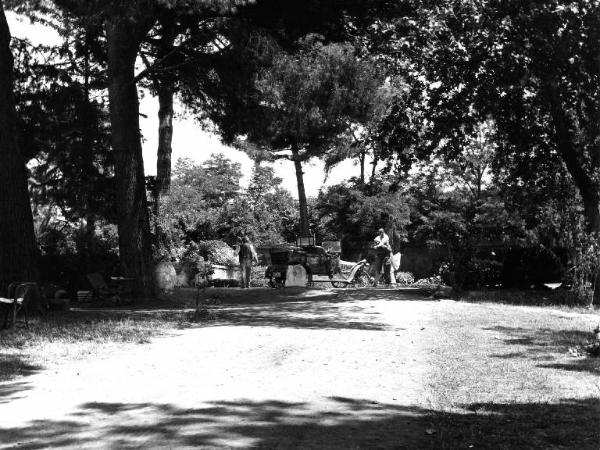 Scena del film "Il padrone sono me" - Regia Franco Brusati - 1955 - Due attori non identificati abbracciati vicino a un'automobile in un parco