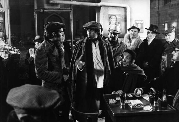 Scena del film "Bianco, rosso e..." - Regia Alberto Lattuada - 1972 - L'attore Adriano Celentano in un bar con attori non identificati