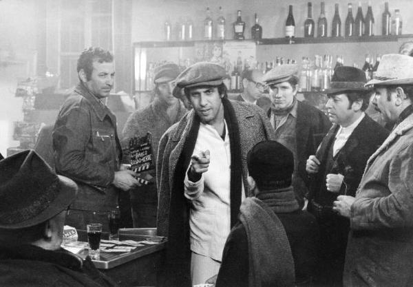 Scena del film "Bianco, rosso e..." - Regia Alberto Lattuada - 1972 - L'attore Adriano Celentano in un bar con attori non identificati