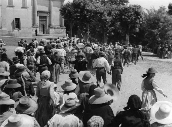 Scena del film "Il mulino del Po" - Regia Alberto Lattuada - 1948 - Una folla di persone si dirige verso una chiesa