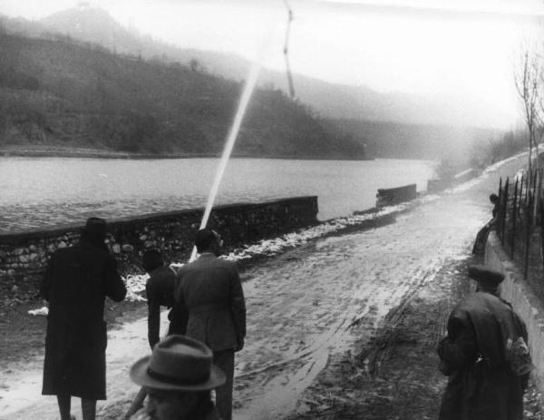 Scena del film "Giacomo l'idealista" - Regia Alberto Lattuada - 1943 - L'attrice Marina Berti seduta su un muretto mentre gli operatori sparano in aria un getto d'acqua da una pompa