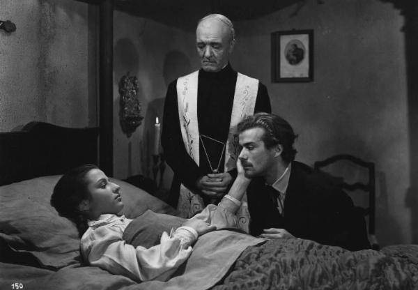 Scena del film "Giacomo l'idealista" - Regia Alberto Lattuada - 1943 - Gli attori Massimo Serato, Marina Berti, a letto, e un prete