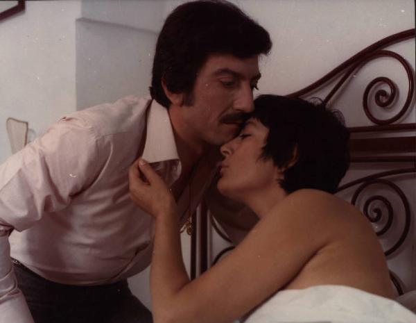 Scena del film "Le farò da padre" - Regia Alberto Lattuada - 1974 - Gli attori Luigi Proietti e Irene Papas a letto