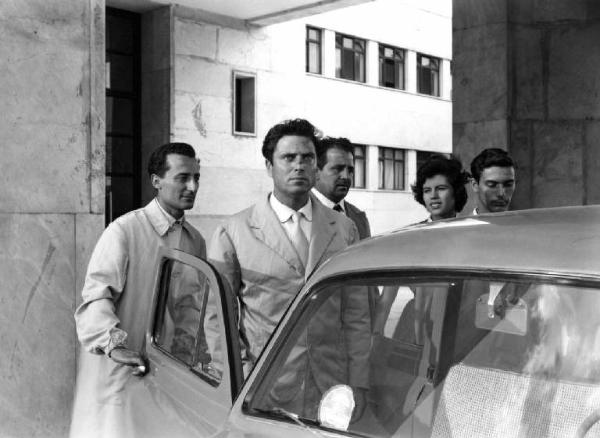 Scena del film "Anna" - Regia Alberto Lattuada - 1951 - L'attore Raf Vallone ferito al naso accanto a un'automobile con attori non identificati