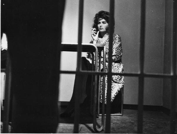 Set del film "Crimen" - Regia Mario Camerini- 1960 - L'attrice Silvana Mangano fuma seduta dietro le sbarre.

.