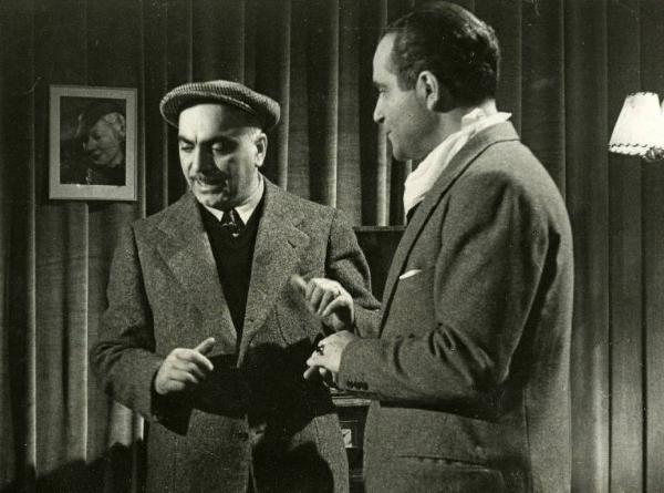 Sul set del film "Documento Z 3" - Regia Alfredo Guarini, 1942 - Il regista Guarini mentre insegna una scena a Tamberlani.