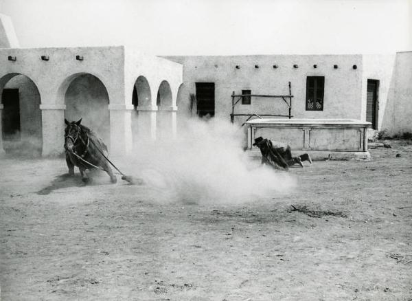 Scena del film "Un dollaro tra i denti" - Regia Luigi Vanzi, 1966 - Totale di un cavallo che, cadendo, scalza un pistolero dalla sella.