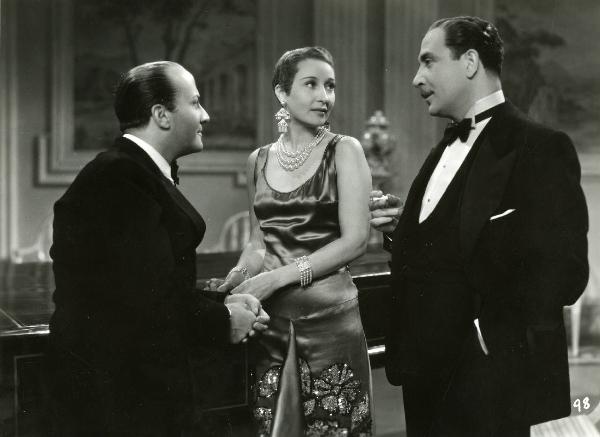 Scena del film "Enrico IV" - Regia Giorgio Pastina, 1943 - Luigi Pavese, a destra, conversa con una sigaretta nella mano, osservato da Osvaldo Valenti, a sinistra e Clara Calamai, al centro.