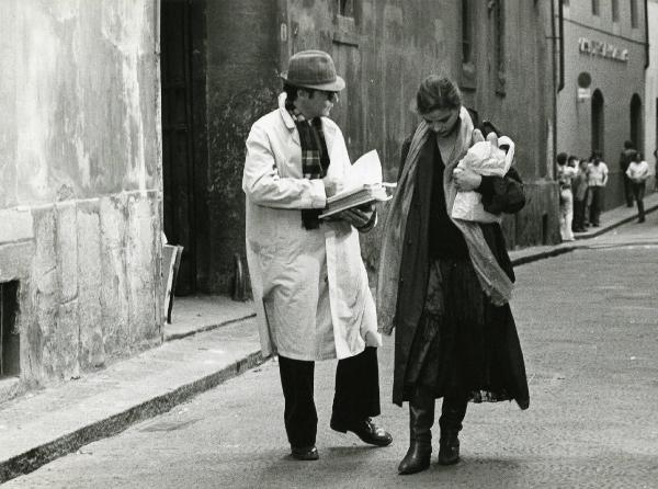 Scena del film "Eutanasia di un amore" - Regia Enrico Maria Salerno, 1978 - A destra, Ornella Muti, reggendo un sacchetto con del pane, guarda verso il basso e ascolta Tony Musante, a sinistra, che, di profilo con dei libri in mano, le parla.