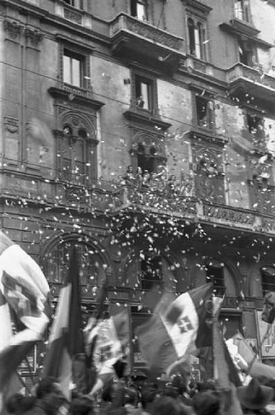 Milano. Via Dante. Manifestazione monarchica. Volantini cadono sulla folla che sfila con le bandiere