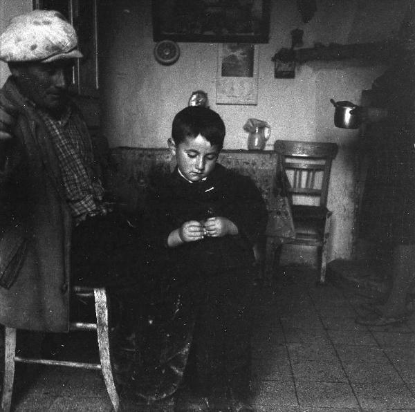 Melissa (Crotone) - Uomo con bambino in un interno di casa