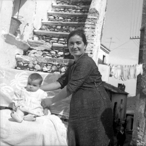 Melissa (Crotone) - Donna con neonato all'esterno di una casa - Ritratto