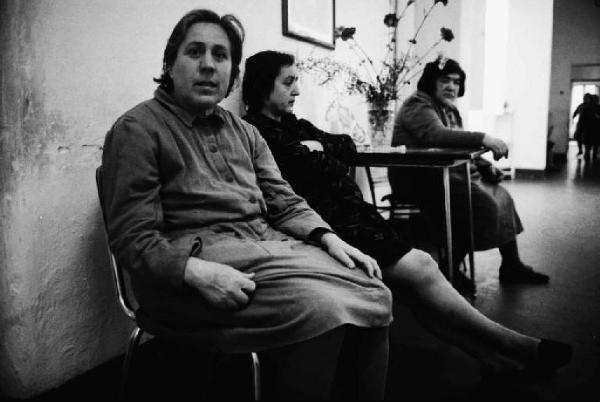 Ritratto di gruppo - adulte sedute nel corridoio di un ospedale psichiatrico