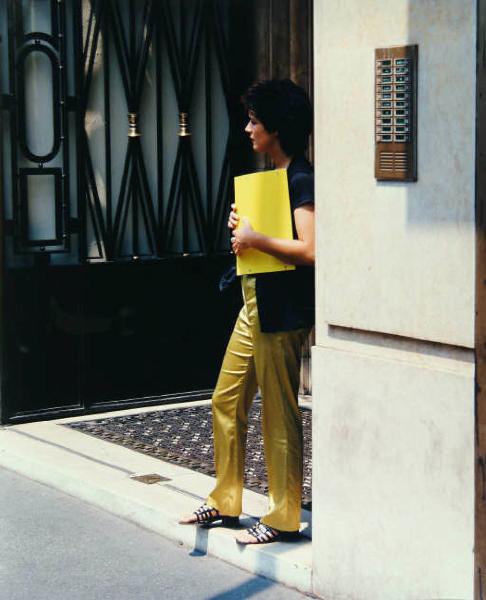 Milano - Centro urbano - Portone di edificio - Ritratto femminile: donna in attesa